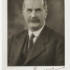 Image: Head and shoulder shot of bald man wearing suit