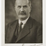 Image: Head and shoulder shot of bald man wearing suit