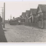 A row of bluestone houses with terracotta tiled roofs