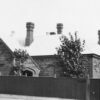 Exterior of Queen's College after a new verandah had been installed