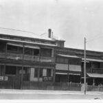 Image: A couple of two storey brick buildings alongside eachother on Whitmore Square