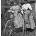 Image: two girls standing outside with their new bicycles