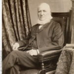 Image: man with beard sitting in chair