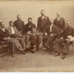 Image: nine men posing for a portrait, six are seated, four are standing