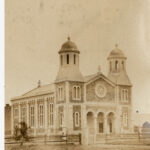 Image: View of a church with grass in the foreground