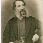 Image: Black and white photograph of a seated man in mid nineteenth century attire.