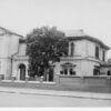 Image: large building with small cross on roof