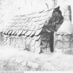 Image: hut with gabled roof and chimney made entirely from circular shaped hessian bags