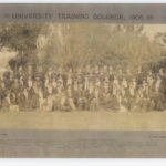 Image: A large group of Caucasian men and women in early Edwardian attire pose for a photograph in front of a stand of trees. All are wearing academic graduate gowns. A notation at the top of the photo reads: ‘University Training College, 1905’