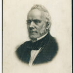 Image: head and shoulders portrait of a man with sideburns