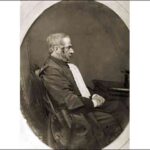 Image: Photograph of seated man in profile.