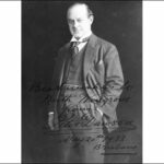 Image: A middle-aged, clean-shaven man in a suit poses for a full-length photographic portrait. An autograph on the photo reads ‘Best Wishes to Keith Wingrove from Peter Dawson, May 20th 1933, Brisbane’