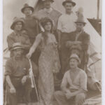 Image: group of men with centre man dressed up as a woman