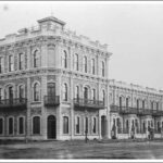 Image: black and white shot of ornate three-storey building of Classical Revival style