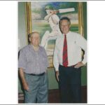 Image: Two men standing in front of painting