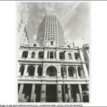 Image: a large modern skyscraper rises above an old three storey stone building with arched windows and balconies