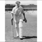 Image: man walking with cricket bat