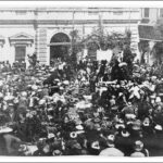 Image: crowd of people in front of stone building