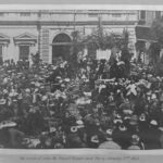 Image: crowd of people in front of stone building