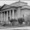 Image: Image: a stone building with six columned portico and decorative pediment