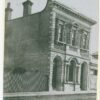 Image: two story building with large arched windows at front