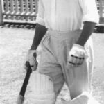 Image: man in cricket whites walking onto oval