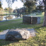 image: rectangular stone memorial and smooth stone bench