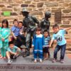 Image: children standing on sculpture