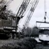 Image: boat being lifted from water by crane