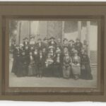 Image: A black and white photograph containing an image of Deborah Moulden amongst her committee members for the S.S. & Nurses' Relatives Association.