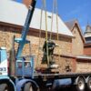 Image: large bronze statue on top of truck