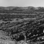 Image: two people walking in hills