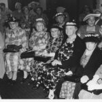 Image: Group of elderly women sitting in a room wearing hats