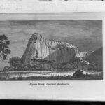 Image: A lithograph of a large stone edifice with a conical peak at one end. A banner beneath the illustration features the words ‘Ayers Rock, Central Australia’