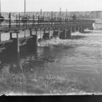 Image: Man standing on bridge over river