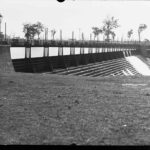 Image: A view a bridge over the river with water running down the steps located under the bridge