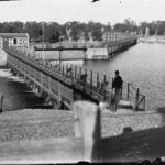 Image: Man standing on bridge over river