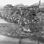 Image: men with wool along river bank