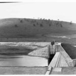 Image: Concrete structure holding back water.