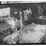 Image: fleece on table with men looking at it