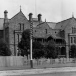 Three storey masonry building with three gable ends