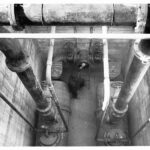 Image: view from above of man amongst large pipes