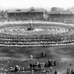 Image: crowds of people on oval watching tableau