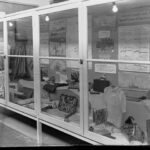 Image: A large display cabinet containing various examples of arts and crafts