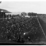 Image: large crowd of people at horse race track