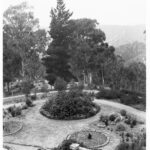 Image: A large garden featuring circular plant and flower arrangements, and winding paths