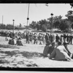 Image: People watching boats by the lake