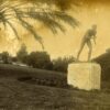 Image: sepia toned photo of statue of naked boy in running pose in a park