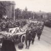 Sir Ross Smith's flag-draped casket passes by as mourners look on