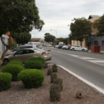 Bitumen roadway with old stone and brick buildings either side